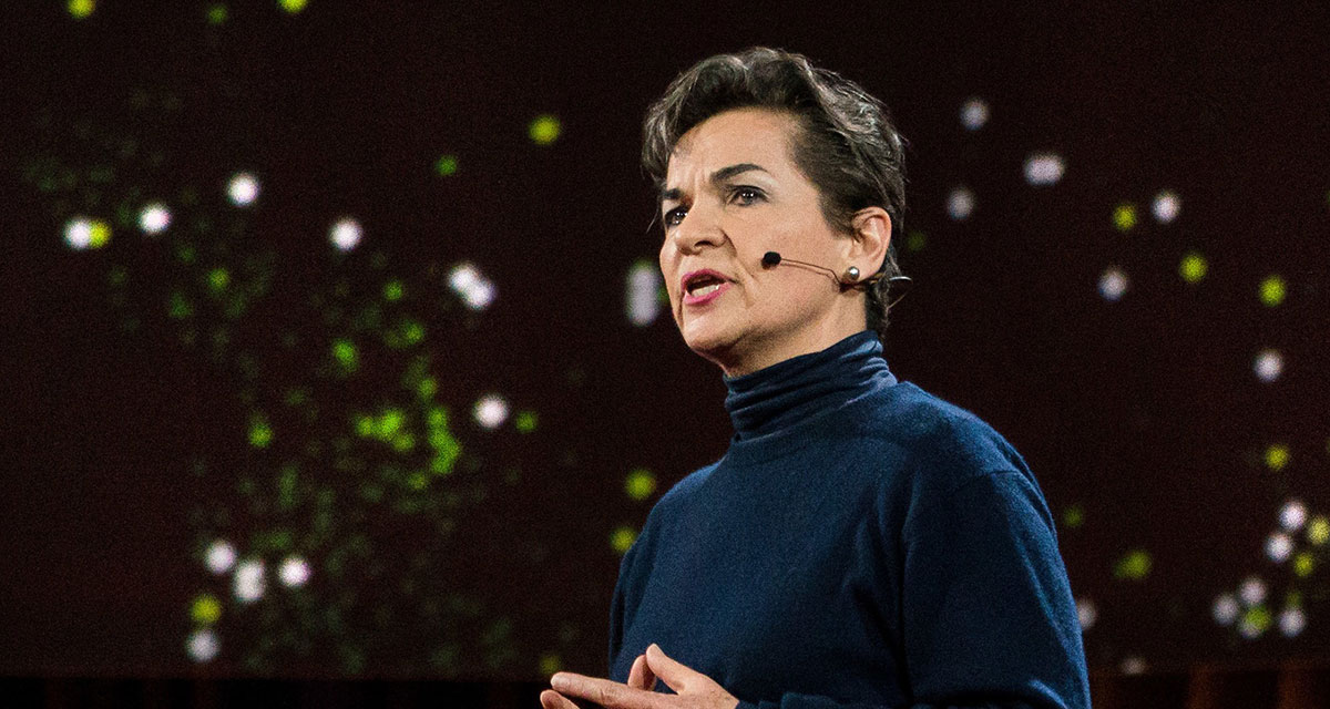 Christiana Figueres speaks on stage at a TED Talk.