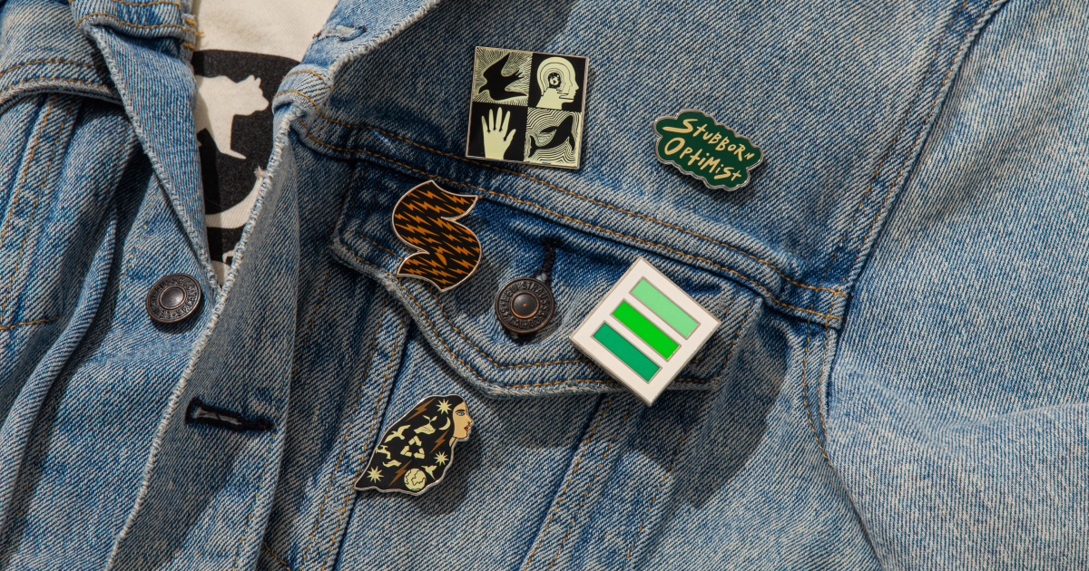 Enamel pin set in The Climate Pledge Collection by Jen Ament.