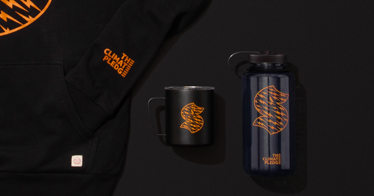 “S” Kraken logo Marine Layer sweatshirt, Miir camper mug, and Nalgene water bottle in The Climate Pledge Collection by Jen Ament.