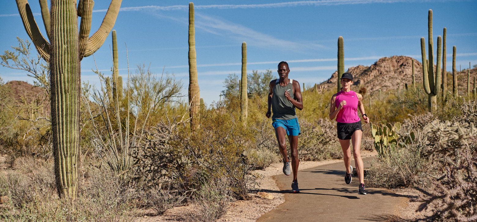 Runners wearing the carbon neutral Ghost 14 shoe on a trail in Tucson, Arizona. Image courtesy of Brooks Running.