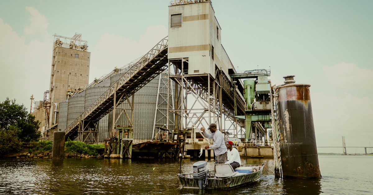 Fishermen in Africatown, Alabama fish near local industries. Photo by Asha Stuart