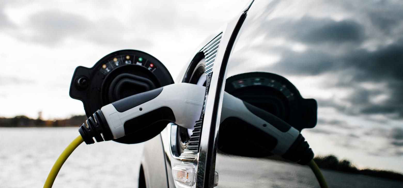 Image of a charger in place as it powers an electric vehicle. 