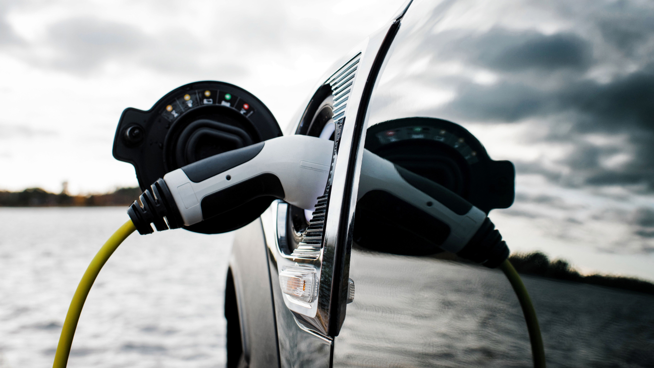 Image of a charger in place as it powers an electric vehicle. 